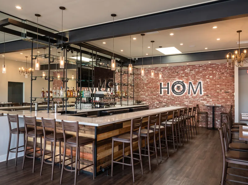 Completed restaurant bar build-out with wood, steel, and brick finishes in Woodland Hills